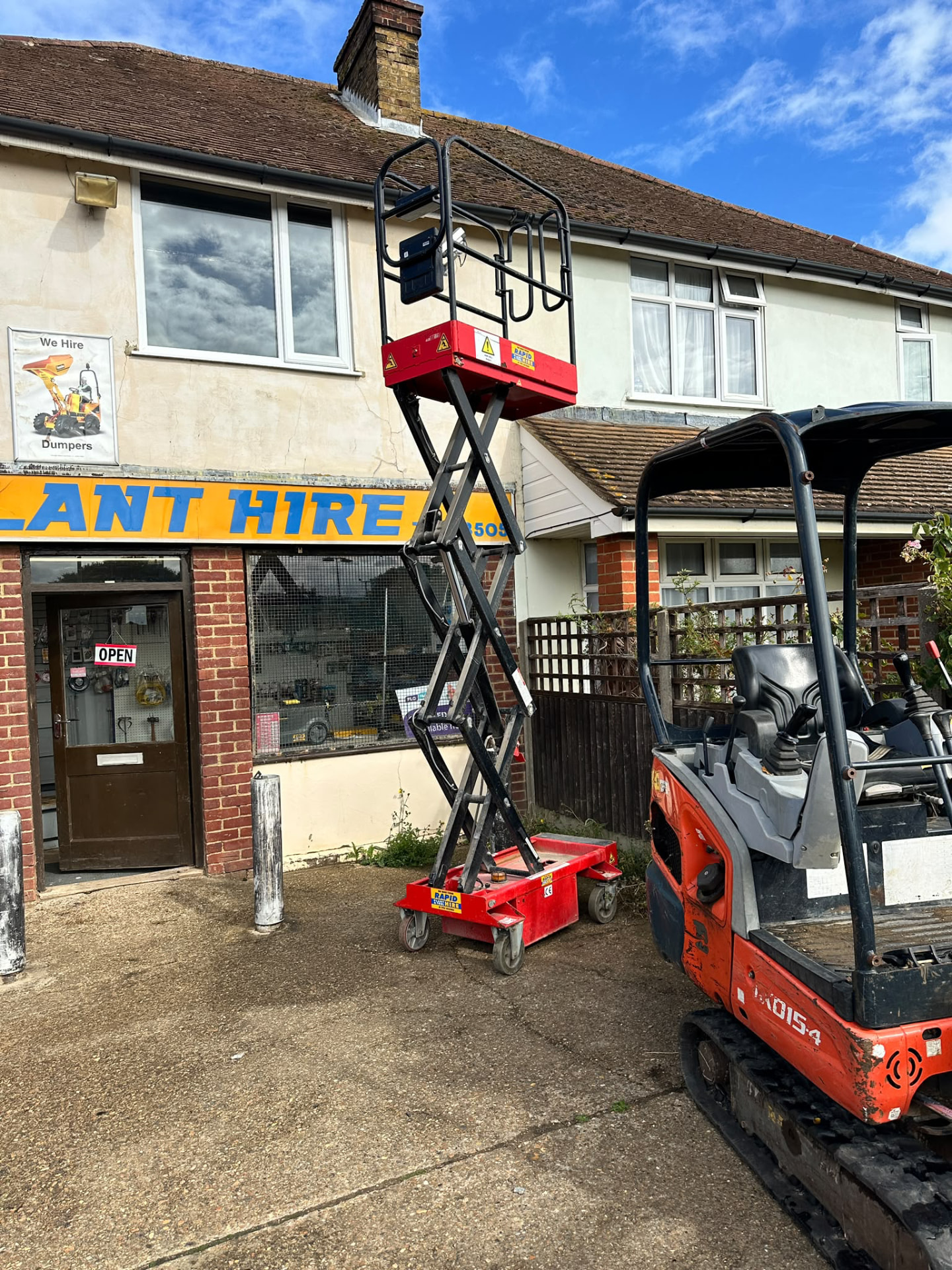 Rapid Plant & Tool Hire shopfront at 38 Vicarage Road, Sittingbourne, with scissor lift and mini digger